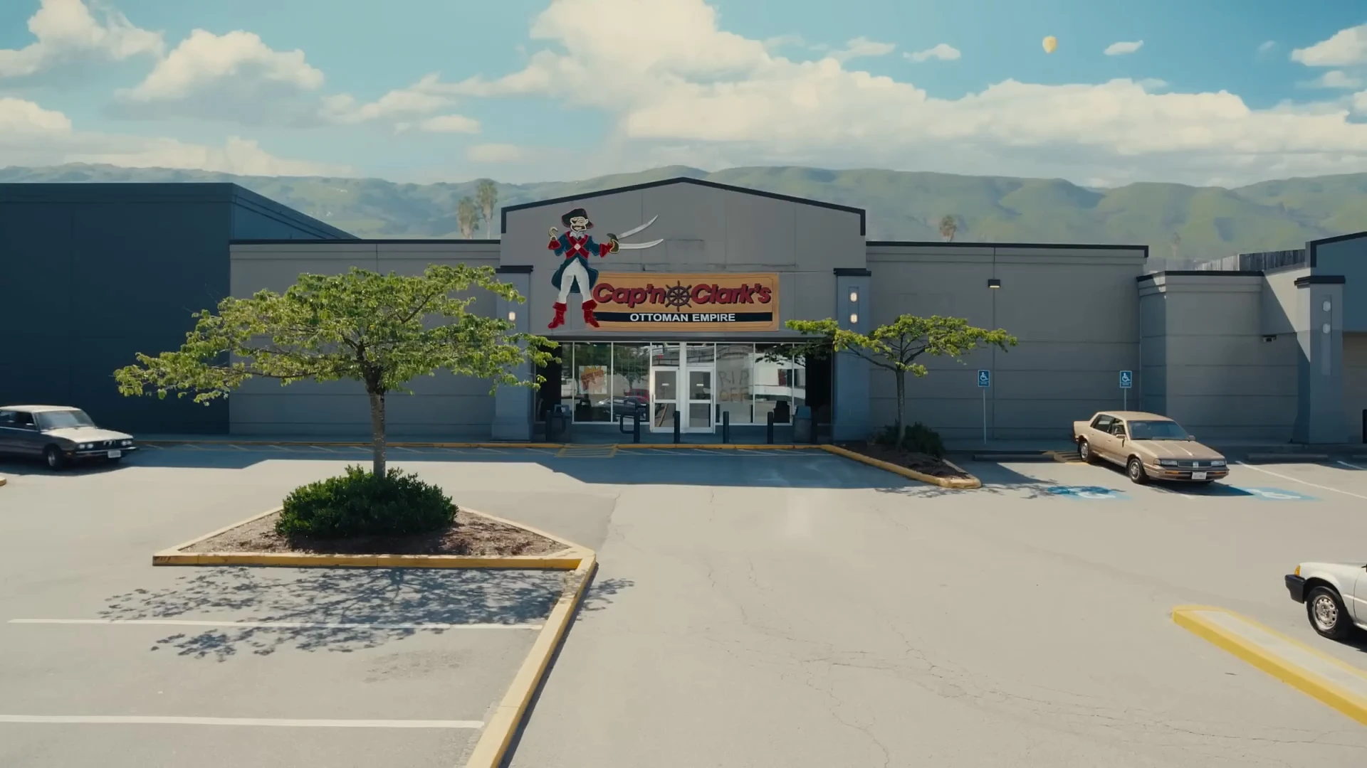 Cap'n Clark's Ottoman Empire storefront: a grey corrugated big box building with cream and red pirate themed signage.